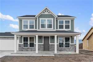 Craftsman-style home with a garage and covered porch