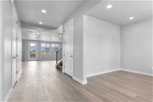 Corridor with light hardwood / wood-style floors