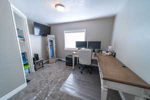 Bedroom with carpet floors and a textured ceiling