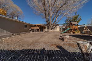 View of yard with a playground and a patio area