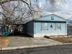 Manufactured / mobile home featuring a corner lot, shed, parking space for 2 cars and a covered porch/deck.
