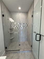 Full bath with baseboards, marble finish floor, recessed lighting, and a stall shower