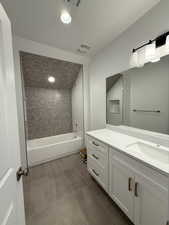 Bathroom with recessed lighting, tile patterned flooring, shower / bathtub combination, visible vents, and vanity