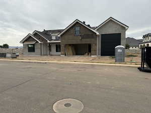 View of front of house with central air condition unit and a garage