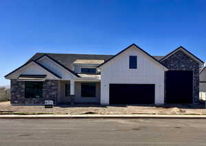 Modern farmhouse style home featuring a garage