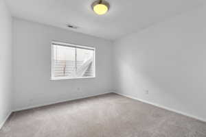 Unfurnished room featuring light carpet