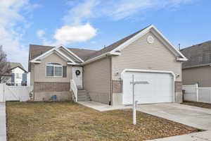 View of front of property featuring a garage and a front yard