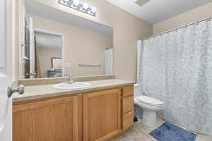 Bathroom featuring tile floors, toilet, and vanity