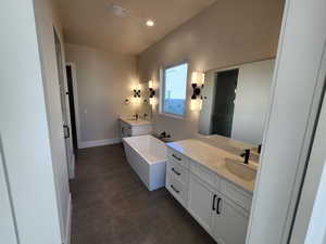 Bathroom featuring shower with separate bathtub and vanity