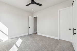 Unfurnished bedroom featuring carpet floors, recessed lighting, baseboards, and a ceiling fan