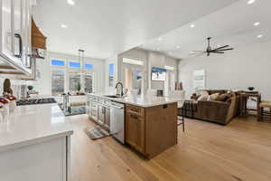 Kitchen with a sink, stainless steel dishwasher, and recessed lighting