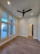 Unfurnished room featuring light wood-type flooring and ceiling fan