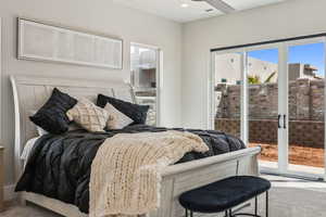 Carpeted bedroom with access to outside