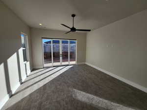 Carpeted empty room featuring ceiling fan