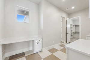 Mudroom with recessed lighting, baseboards, visible vents, and light floors