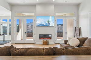 Living area featuring visible vents, french doors, and wood finished floors