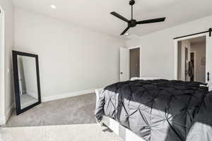 Bedroom with a barn door, carpet floors, a ceiling fan, baseboards, and recessed lighting