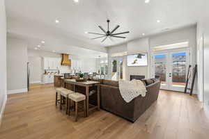 Living area with french doors, recessed lighting, baseboards, a ceiling fan, and light wood-type flooring