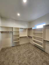 Walk in closet featuring carpet flooring