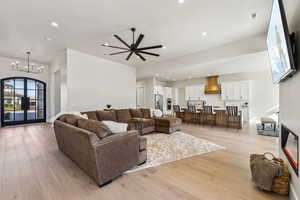 Living area with recessed lighting, light wood-style flooring, and visible vents