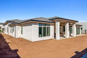 Rear view of property featuring a patio and stucco siding