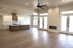 Kitchen featuring a large island, custom exhaust hood, and french doors