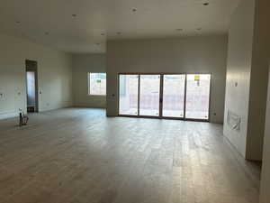 Empty room with light hardwood / wood-style floors