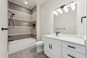Bathroom with vanity, bathing tub / shower combination, and toilet