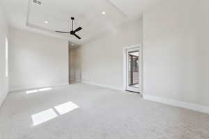 Spare room with ceiling fan, visible vents, light colored carpet, baseboards, and recessed lighting