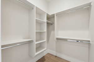 Walk in closet featuring wood finished floors