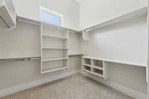 Spacious closet with light colored carpet