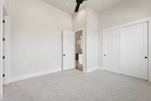 Unfurnished bedroom featuring a closet, carpet flooring, and baseboards