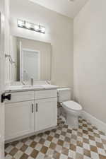 Bathroom featuring tile patterned floors, vanity, and toilet