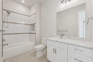 Bathroom with recessed lighting, vanity, shower / bathtub combination, and toilet