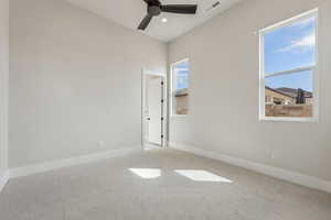 Unfurnished room featuring visible vents, a ceiling fan, baseboards, and carpet floors