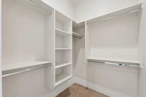 Walk in closet featuring light wood-type flooring