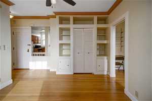 Great Room with Closet/Built-in Shelves & Cabinets and Crown Moldings