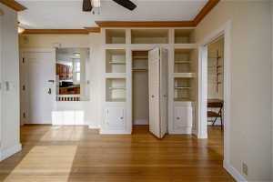 Great Room with Closet/Built-in Shelves & Cabinets and Crown Moldings
