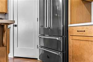 Kitchen featuring dark hardwood / wood-style flooring and high end fridge