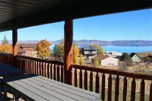 Wooden deck featuring a water and mountain view