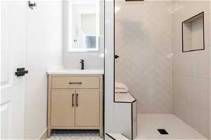 Bathroom with tile walls, vanity, tile flooring, and tiled shower