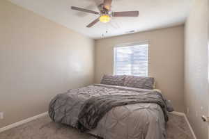 Bedroom with ceiling fan and carpet flooring