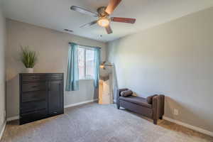 Sitting room featuring ceiling fan and light carpet