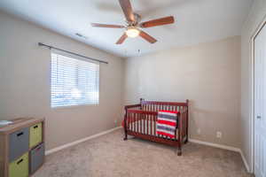 Bedroom featuring ceiling fan and light colored carpet