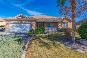 Ranch-style home with a front yard and a garage