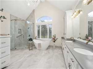 Master Bathroom featuring double vanity, plus walk in shower, tile flooring, and lofted ceiling