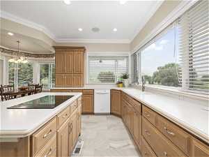 Kitchen with sink, light tile floors, a notable chandelier, and a healthy amount of sunlight