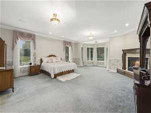 Master Bedroom featuring access to outside, crown molding, and light-colored carpet