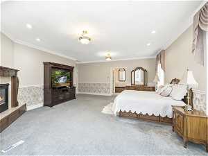 Master bedroom, Carpeted bedroom featuring ornamental molding and a tile fireplace