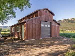 Garage with a rural view and a mountain view
